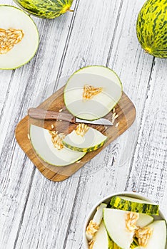 Portion of Fresh Futuro Melon on wooden background selective fo photo