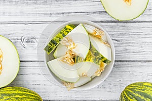 Portion of Fresh Futuro Melon on wooden background selective fo photo