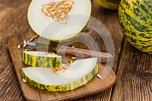 Portion of Fresh Futuro Melon on wooden background & x28;selective fo photo