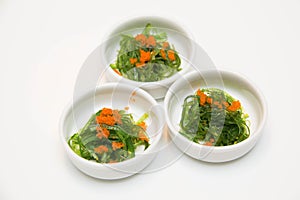 Portion of fresh wakame seaweed on a white background