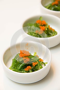 Portion of fresh wakame seaweed on a white background