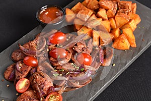 portion of fried Calabrian sausage with onion and roasted potatoes with spices and paprika photo