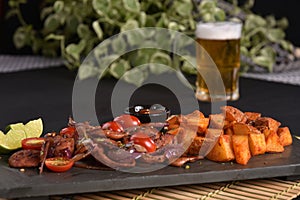 portion of fried Calabrian sausage with onion and roasted potatoes with spices and paprika photo