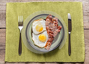 Portion of fried eggs with bacon