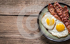 Portion of fried eggs with bacon