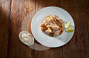 Portion of fried tilapia with mayonnaise