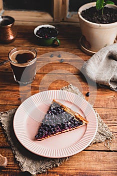 Portion of Galette with Berries of Shadbush and Glass of Coffee