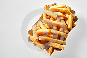 Portion of golden pommes frites isolated on white photo