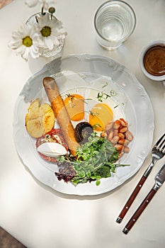 Portion of breakfast with sausage and fried eggs