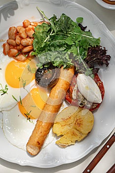 Portion of breakfast with sausage and fried eggs