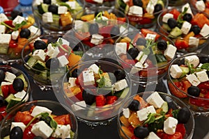 Portion Greek salad on the table. Catering for events, celebrations and business meetings. Close-up