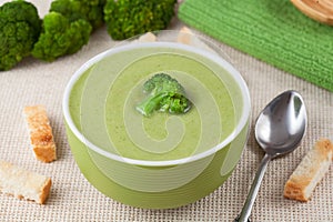 Portion of green broccoli cream soup restaraunt