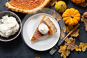 Portion of homemade thanksgiving pie with whipped cream