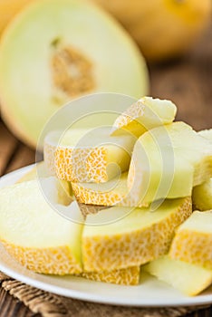 Portion of Honeydew Melon on wooden background selective focus