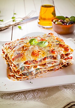 Portion of lasagne with bolognese and cheese photo