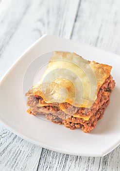 Portion of lasagne on the white plate