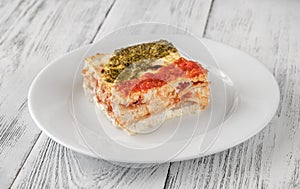 Portion of lasagne on white plate