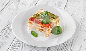 Portion of lasagne on white plate