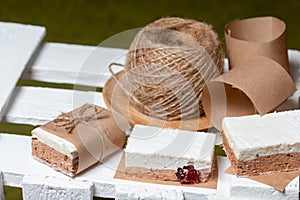 Portion marshmallow with cocoa and cranberries. Wrapped in paper and tied with string. Two-layer zephyr