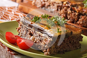 Portion of moussaka with eggplant on a plate macro. horizontal