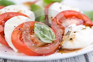 Portion of Mozarella with Tomatoes and Balsamico dressing