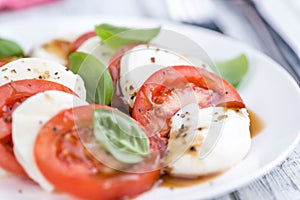 Portion of Mozarella with Tomatoes and Balsamico dressing