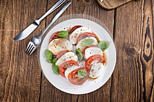 Portion of Mozarella with Tomatoes and Balsamico dressing