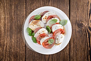 Portion of Mozarella with Tomatoes and Balsamico dressing