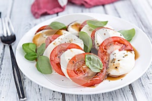 Portion of Mozarella with Tomatoes and Balsamico dressing