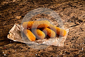 Portion of Mozzarella Sticks on an old wooden table