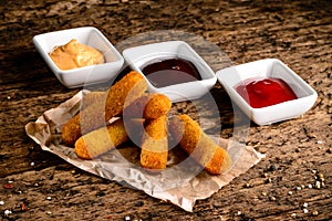 Portion of Mozzarella Sticks on an old wooden table