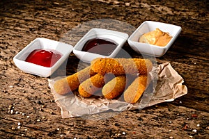 Portion of Mozzarella Sticks on an old wooden table