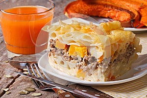 Portion of pasta baked with meat, cheese and pumpkin