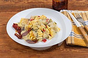 Portion of pasta casserole with supplemented sun-dried tomatoes