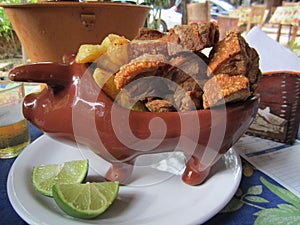Portion of pork rinds with cassava photo