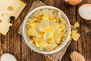 Portion of Potato Chips Cheese and Onoion taste on wooden back