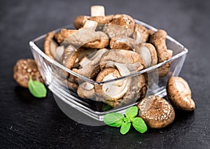 Portion of raw shiitake mushrooms on a slate slab