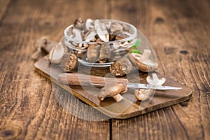 Portion of Raw Shiitake mushrooms on wooden background, selective focus