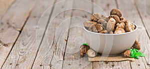 Portion of Raw Shiitake mushrooms on wooden background, selective focus