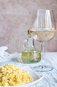 Portion of risotto with glass of white wine