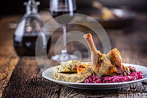 Portion of roast duck leg red cabbage homemade dumplings on plat