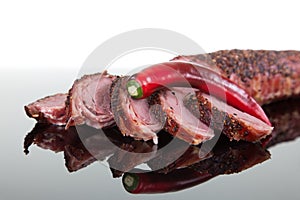 Portion of roast pork sliced into small pieces, decorated with r