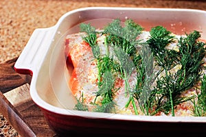 A portion of salmon being cured for gravlax