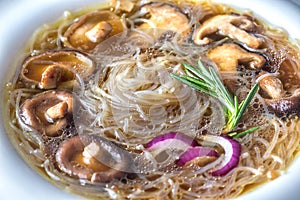 Portion of shiitake ginger soup on the wooden table