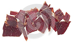 Portion of sliced and dried meat isolated on white background. Top view of beef jerky pieces