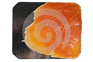 Portion of smoked salmon on foil paper isolated on white. Fish product