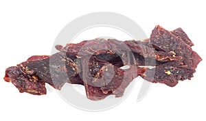 Portion of spices beef jerky pieces isolated on white background. Dried beef meat