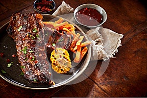 Portion of spicy barbecued spare ribs with veggies