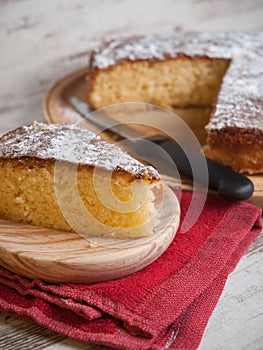 Portion of a sponge cake on a wooden plate