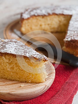 Portion of a sponge cake on a wooden plate